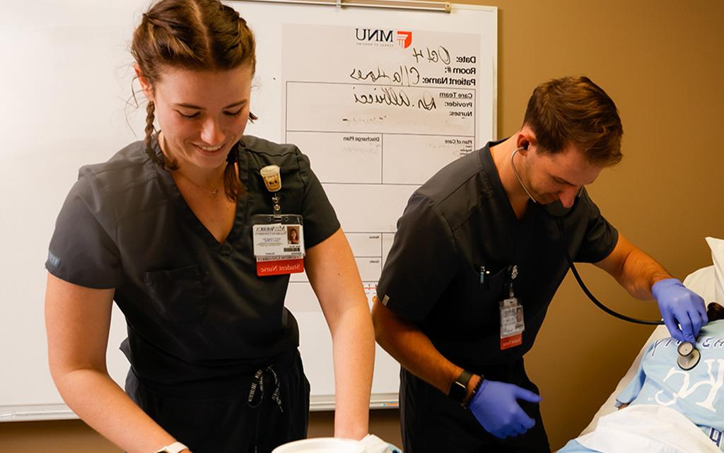 Two nursing students in a simulation lab